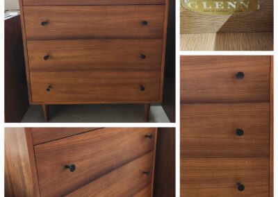 Wooden chest of drawers with four drawers and simple round knobs.