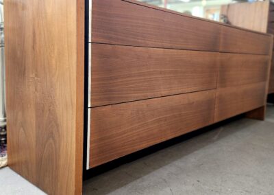 Sleek wooden sideboard with smooth drawer fronts and a modern design.