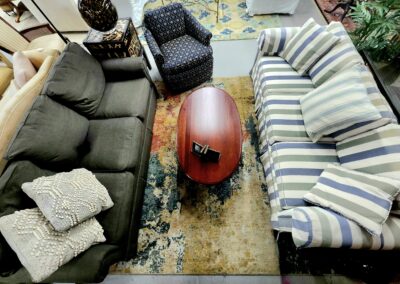Cozy living room with mixed patterned sofas and a central wooden coffee table.