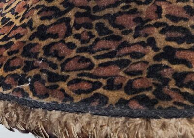 Close-up of a leopard print fabric with fringed edge.