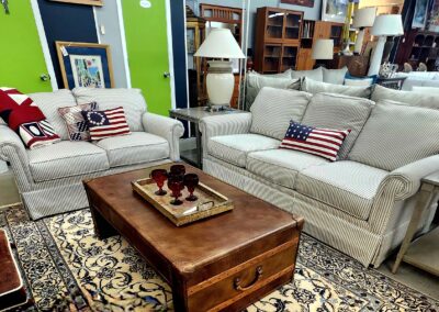 Cozy living room with beige sofas and patriotic cushions.