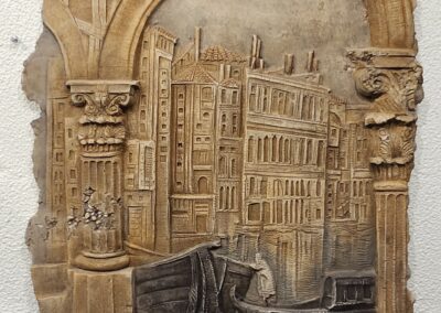 A carved wooden relief of a Venetian canal scene.