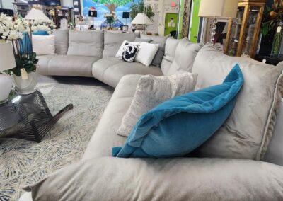 Modern beige sectional sofa with decorative pillows in a cozy living room.