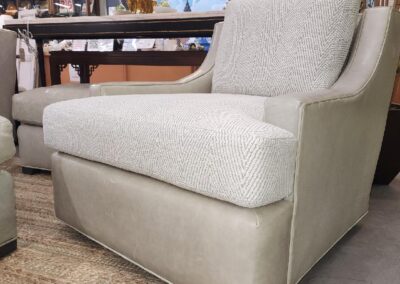 Modern beige fabric loveseat with clean lines on a woven rug.