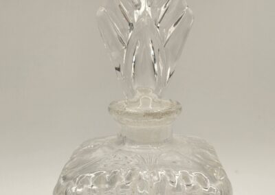 Clear glass decanter with intricate textured patterns and a flame-shaped stopper.