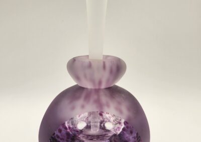 A delicate purple glass vase with a bulbous body and flared neck.
