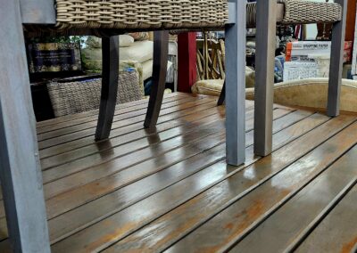 Wooden floor with metal furniture legs and a woven basket.