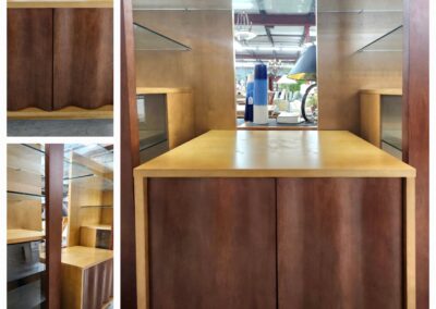 A wooden booth with a brown curtain in a modern indoor space.