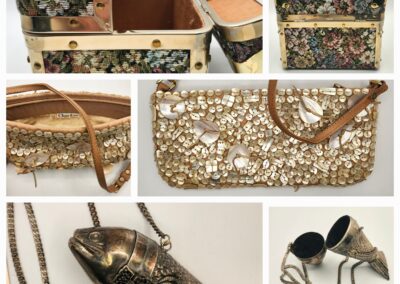 A floral-patterned handbag with intricate gold chain and fish-shaped clasp.