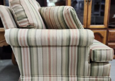 Striped upholstered armchair with a classic design.