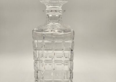 Elegant glass decanter with intricate geometric patterns.