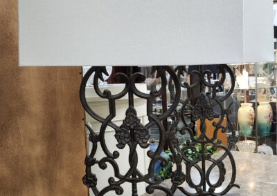 Decorative wrought iron railing with intricate patterns and a reflective surface.
