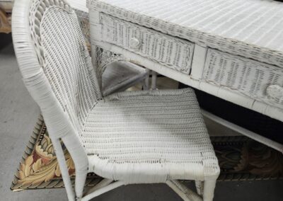 White wicker chair and desk set with woven details.