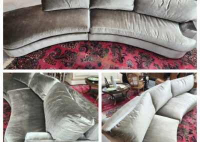 Curved beige sofa set on a patterned red carpet in a cozy living room.