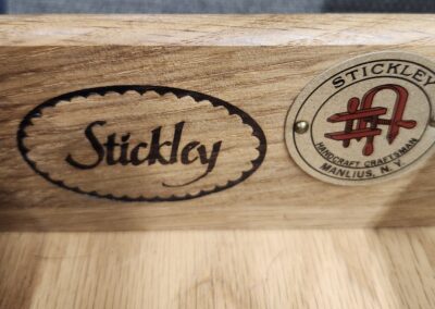 Close-up of wooden Stickley furniture labels.