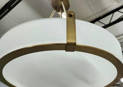Modern pendant light with a frosted glass shade and brass accents.