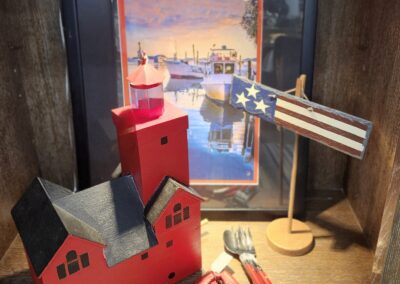 A nautical-themed decorative setup with a lighthouse, a lamp, and a ship model.
