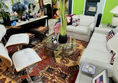 Cozy living room with patterned rug and glass coffee table.