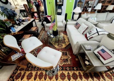 Cozy living room with stylish white chairs and patterned carpet.
