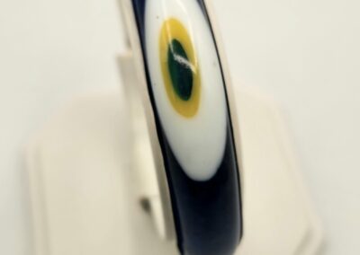 Close-up of a navy blue bracelet with an eye design on display.