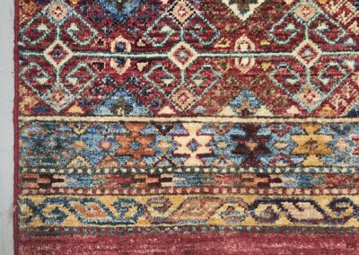 Colorful patterned rug with intricate geometric designs.