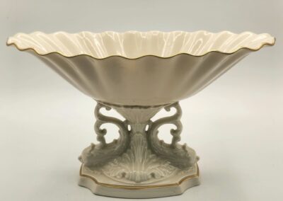 Elegant vintage ceramic pedestal bowl with intricate designs.