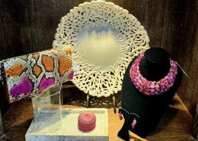 Display with jewelry, a lace doily, and decorative items.