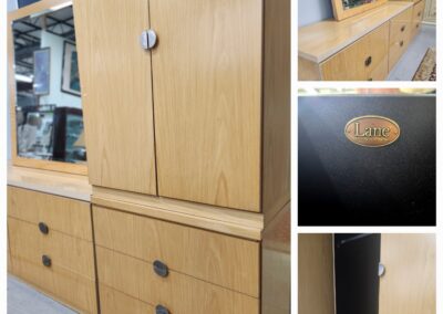 Vintage wooden dresser with multiple drawers and cabinet doors in light wood finish.