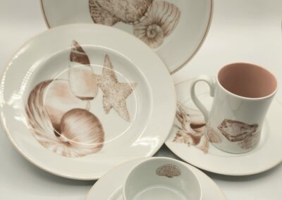 Elegant ceramic dish set with seashell and starfish designs.