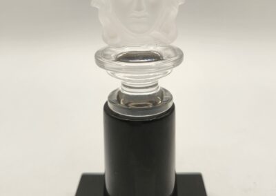 Elegant glass sculpture on a black base with intricate details.