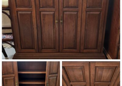 Wooden cabinet with paneled doors and storage shelves inside.