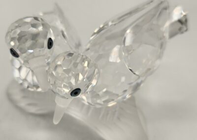 A delicate glass bird figurine with intricate detailing.