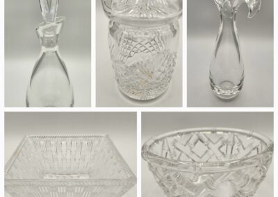 Collection of clear, intricately cut glassware including bowls and vases.