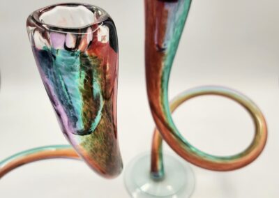 Colorful glass vases with elegant, curved stems.