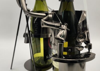 Metal wine bottle holders shaped like musicians playing instruments.