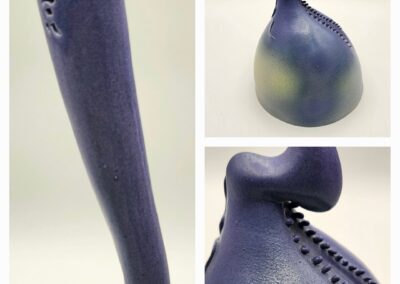 Artistic ceramic sculpture with a twisted, elongated form and gradient blue hues.