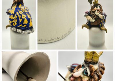 Detailed ceramic figurine of a crowned man holding a scepter, decorated in blue and gold.