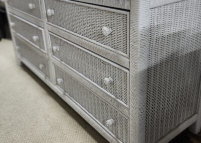 White wicker dresser with six drawers and round knobs.