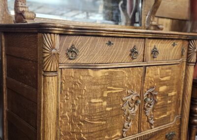 Antique wooden cabinet with intricate carvings and ornate handles.