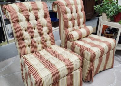 Two striped, tufted dining chairs with a classic design.