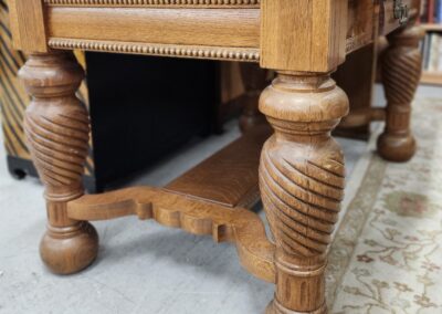 Close-up of ornate wooden table legs with intricate carvings.