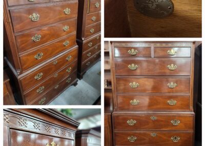 Antique wooden chest of drawers with intricate brass handles and detailed wood inlay.