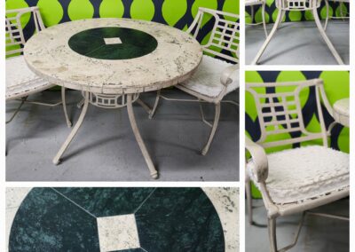 Vintage white metal outdoor furniture with green cushions and a round marble-top table.