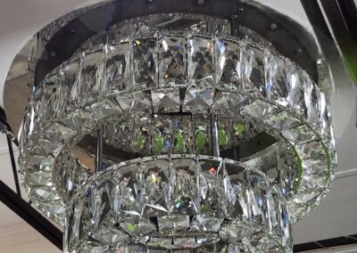 Elegant two-tier crystal chandelier with sparkling prisms.