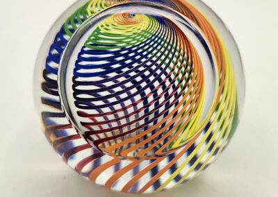 A colorful glass sphere with intricate swirling patterns inside.