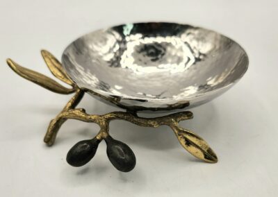 Decorative silver bowl with a branch and olives design.