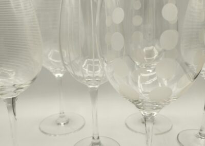 A set of elegant wine glasses with delicate etched designs.