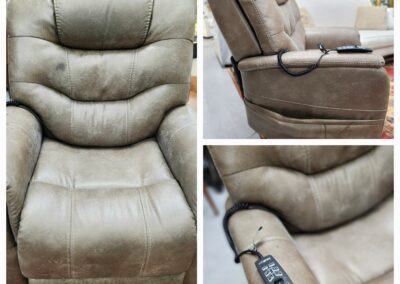 A beige recliner chair with padded cushions and a remote control.