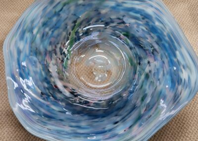 Top view of a blue and white swirled glass bowl.