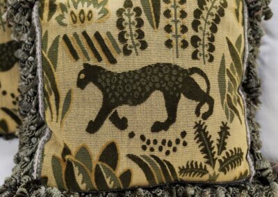 Decorative cushion featuring a stylized black panther and botanical motifs.